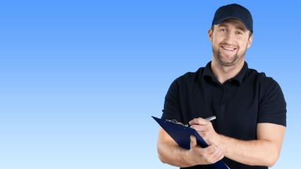 Technician Wearing Hat Holding Clipboard